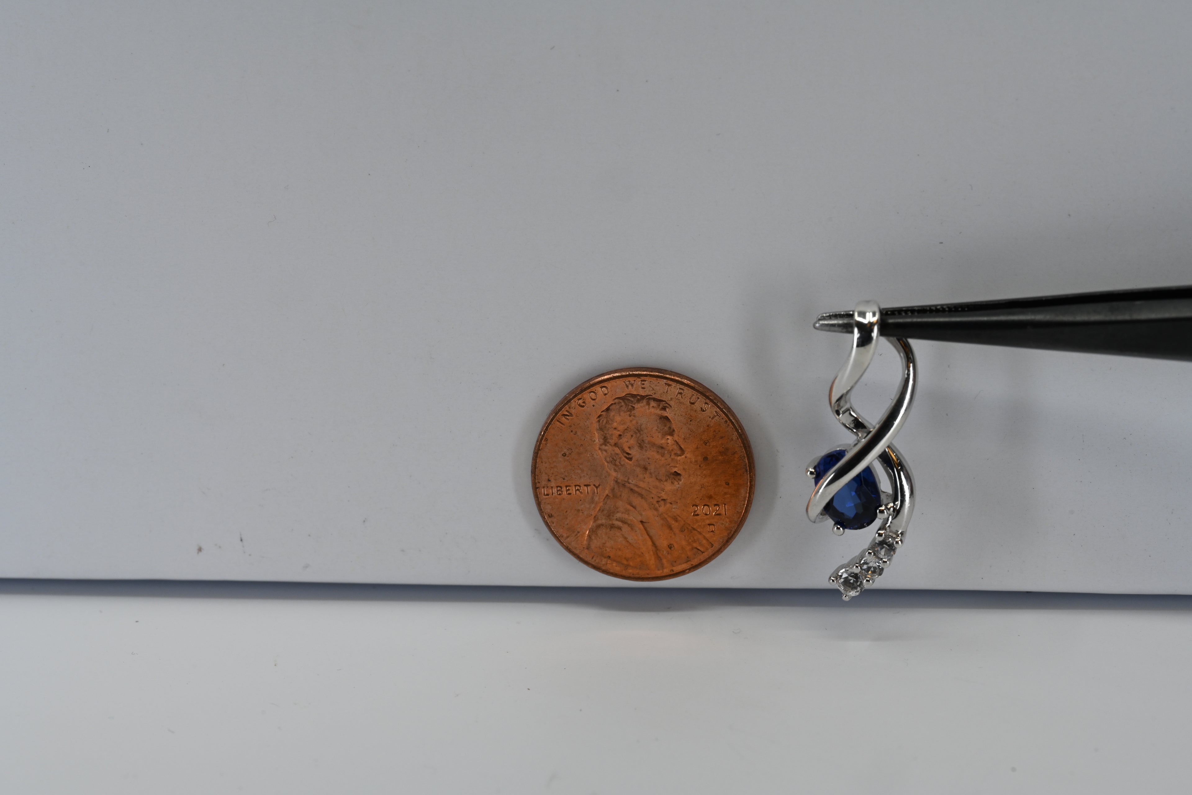 Sterling Silver Oval Blue Stone and Round Colorless Stone Drop Pendant