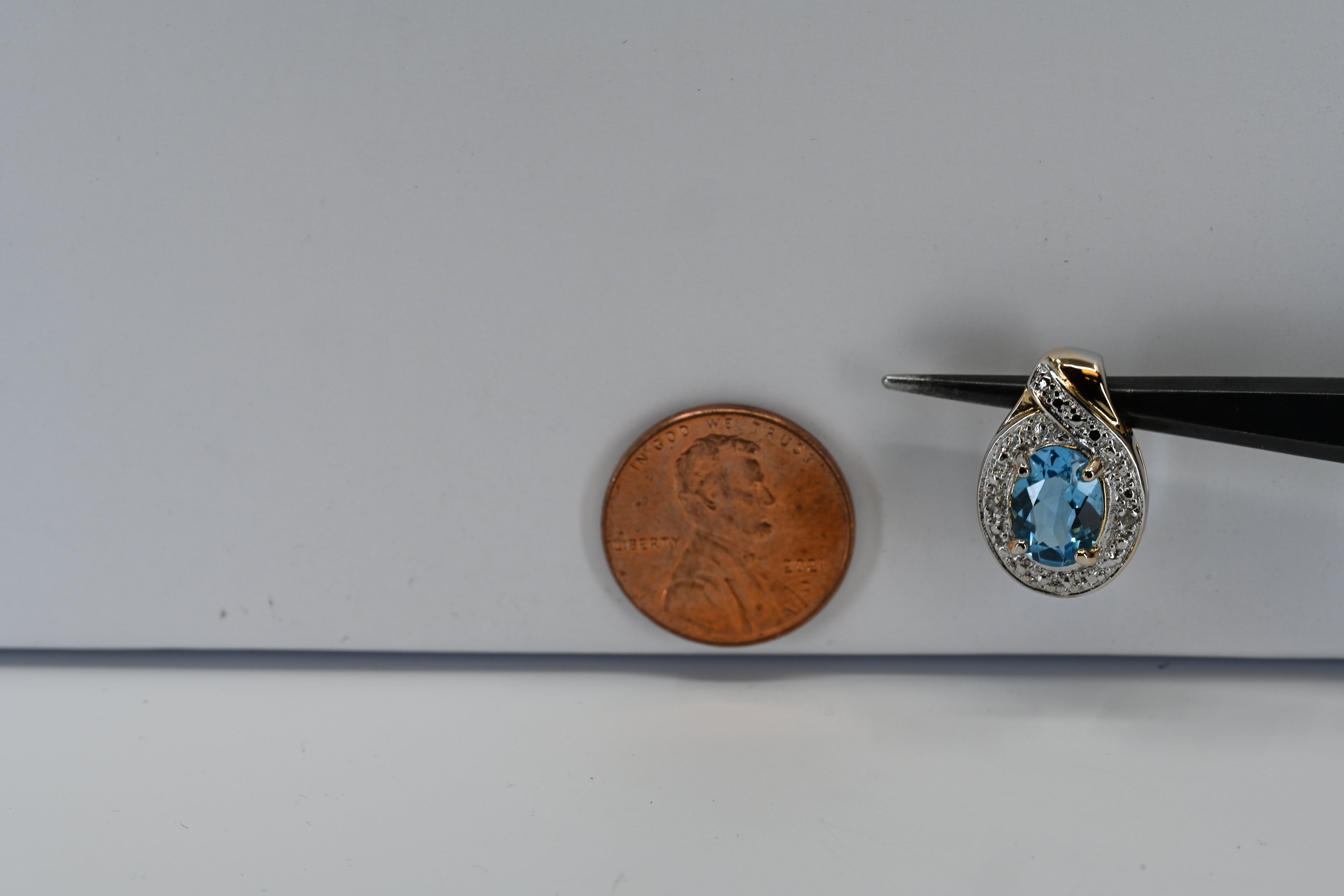 Sterling Silver Oval Blue Stone with Halo Round Colorless Stones pendant