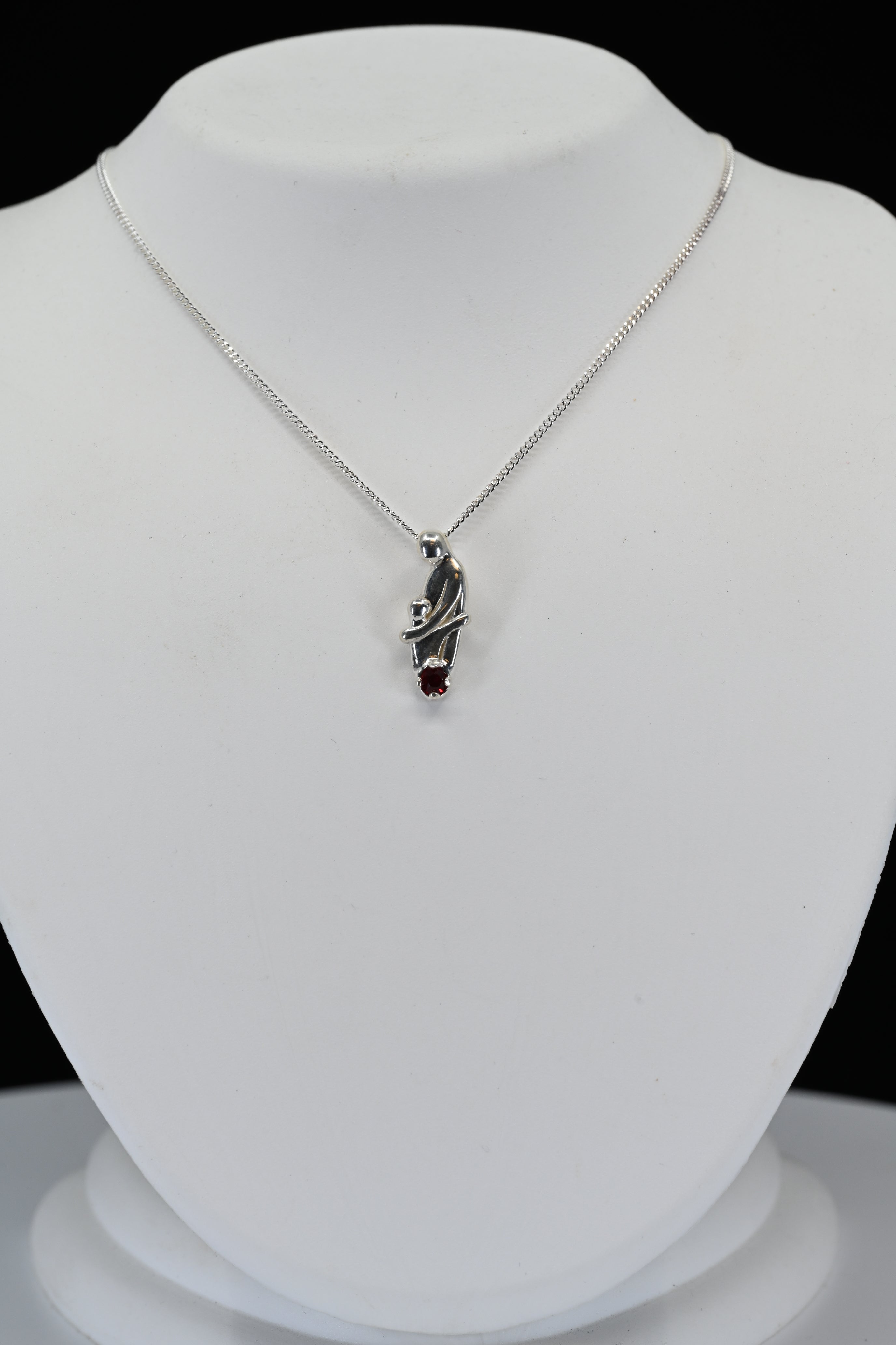 Sterling Silver Round Red Stone Mother Holding Child Necklace