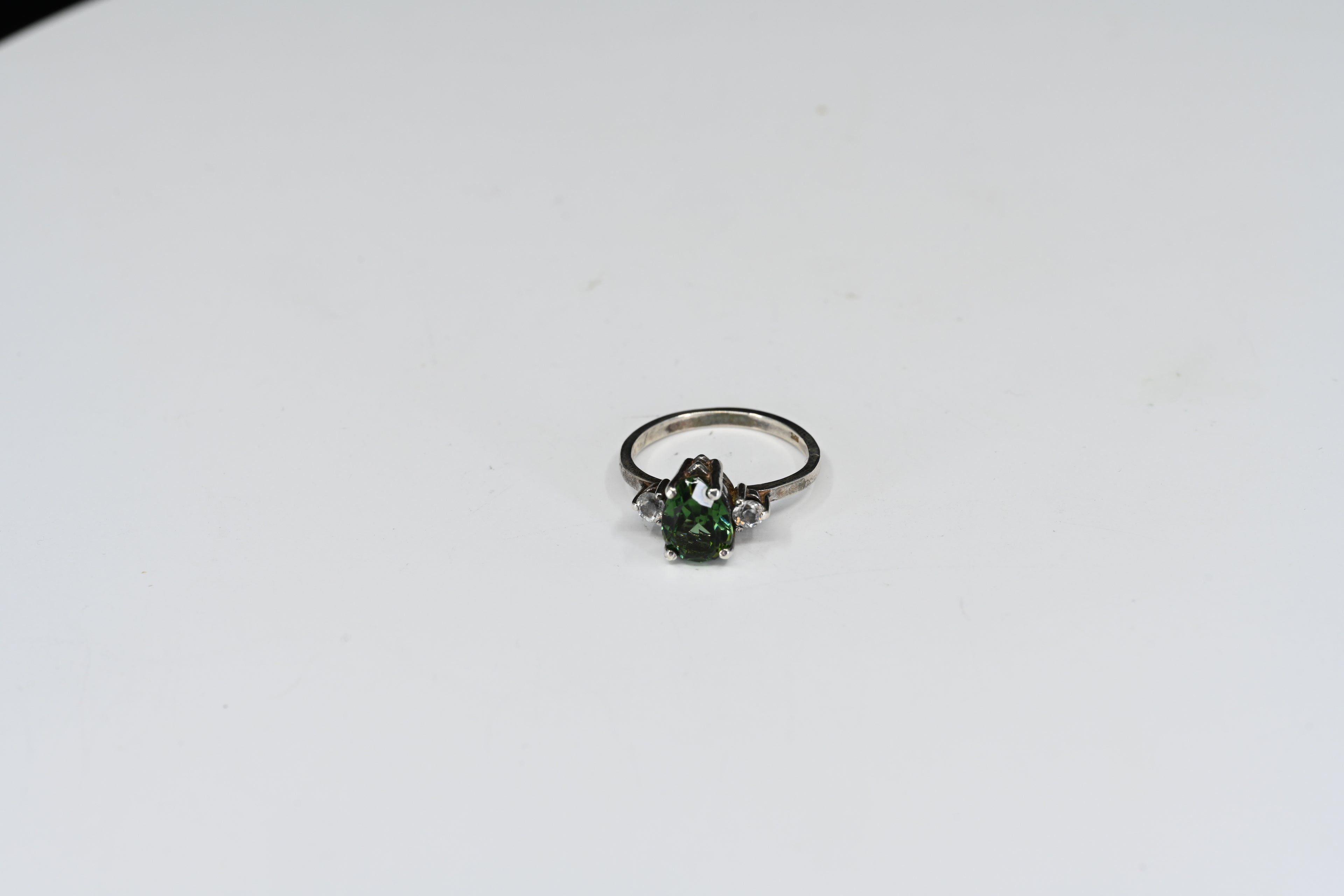 Sterling Silver Green Pear Shape With Round Colorless Stones Three Stone Ring
