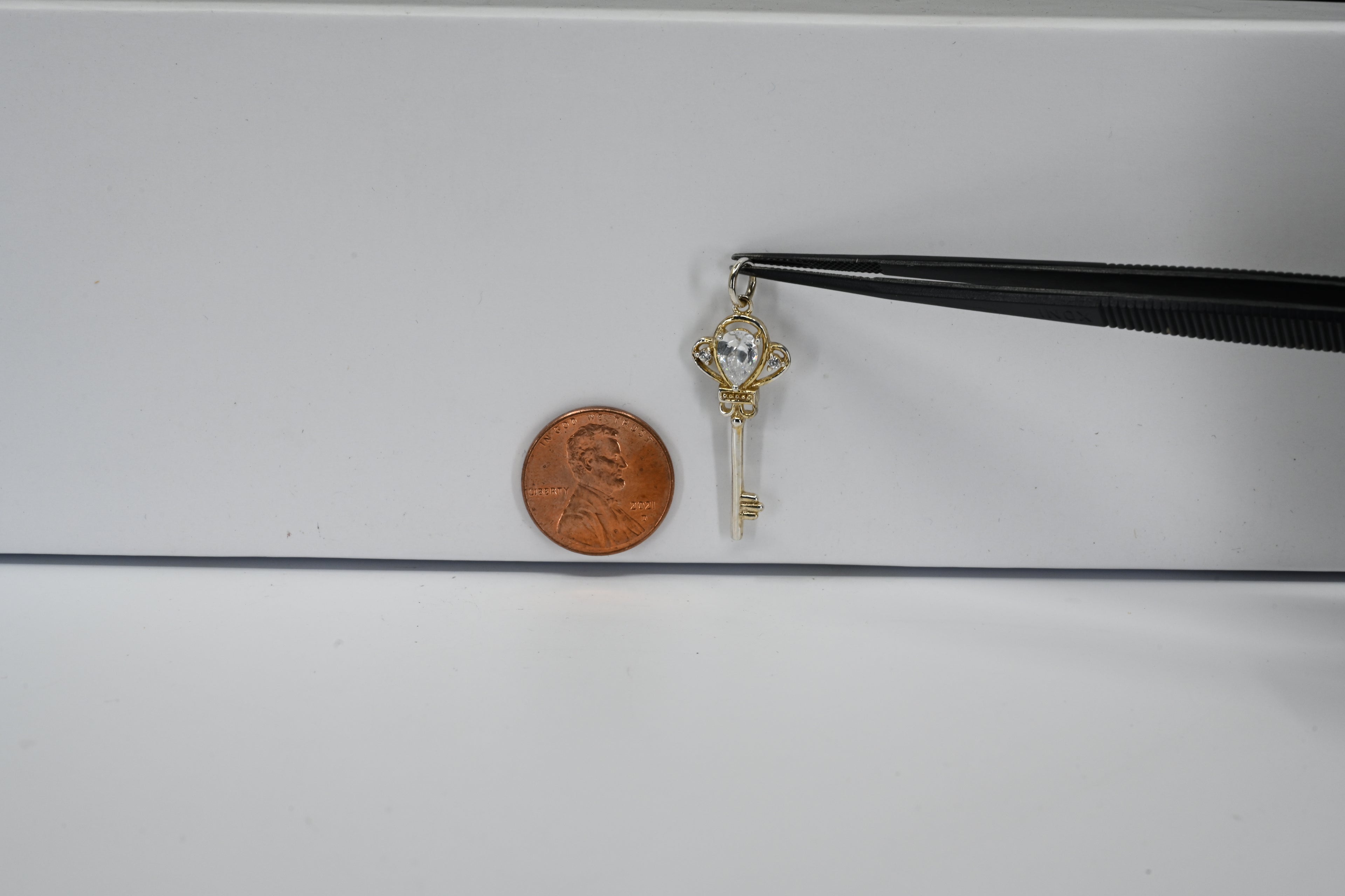 Sterling Silver Pear Shaped Colorless Stone Key Pendant