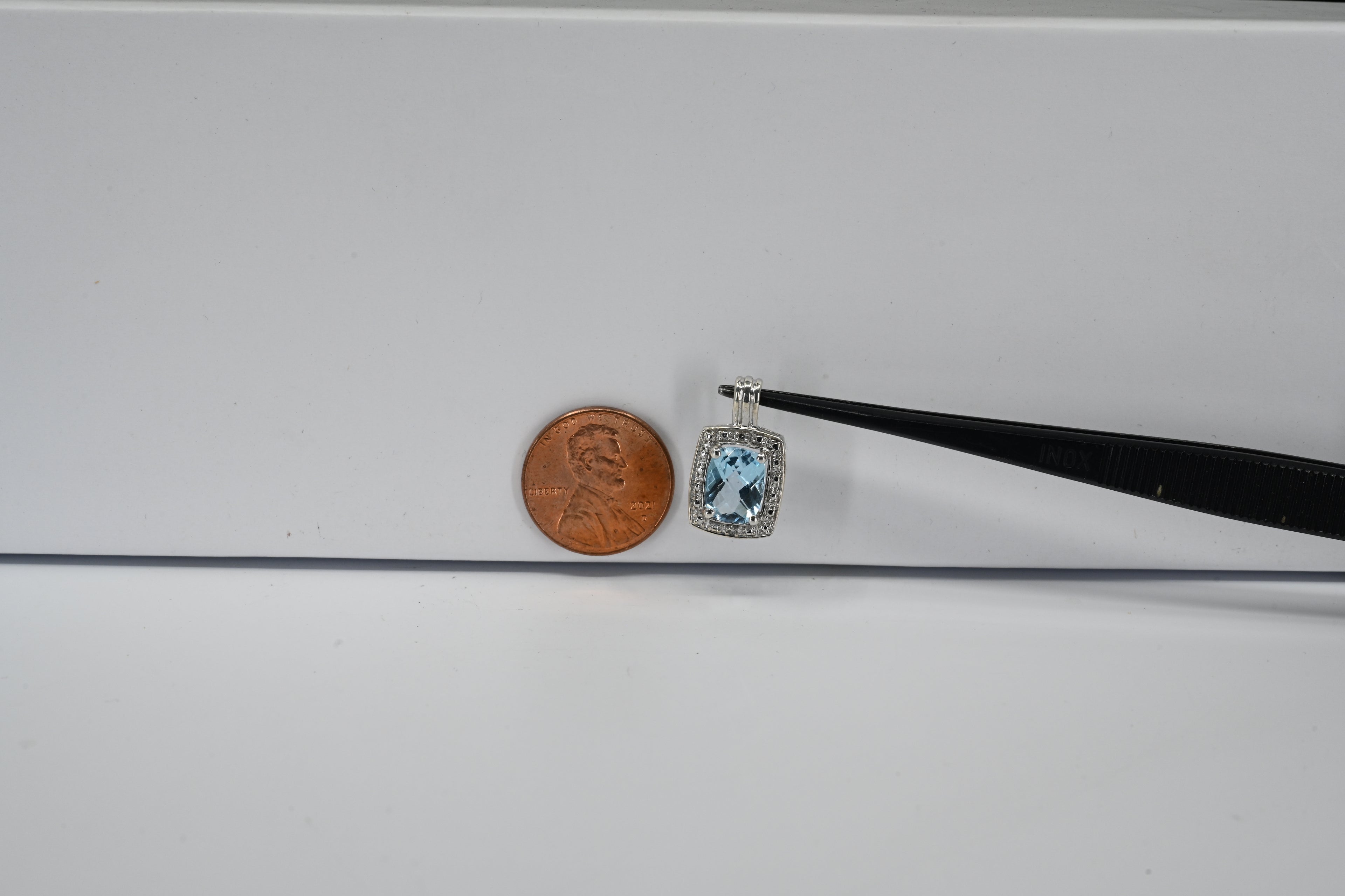 Sterling Silver Blue Center Stone With Round Colorless Halo Rectangle Shaped  Pendant